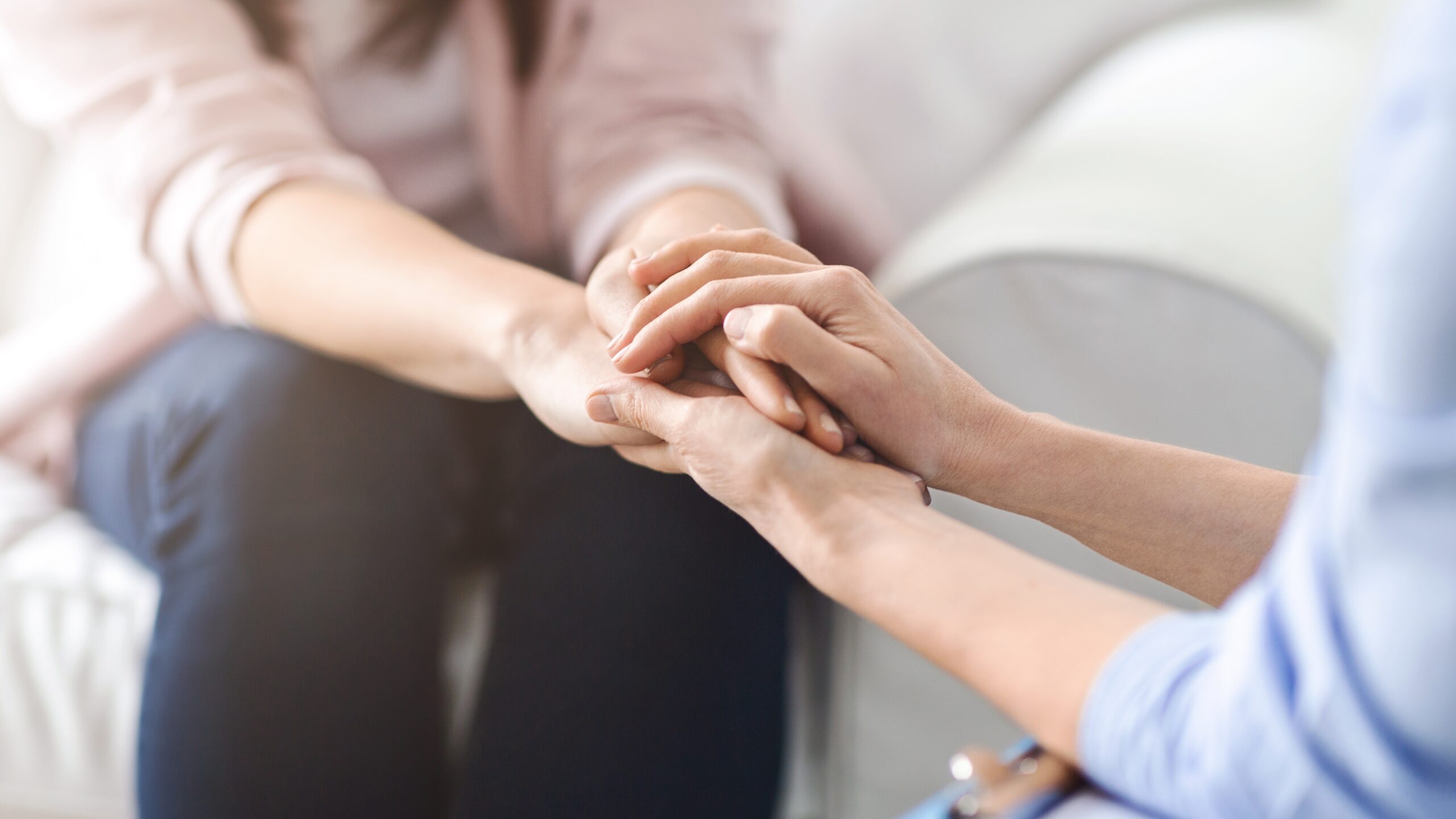 Close-up of hands showing care and support in dental community at Oak Mountain Denture and Implant Center.
